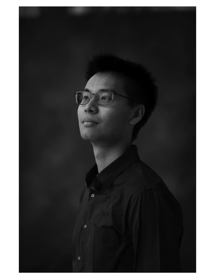 A black and white photo of a man wearing glasses