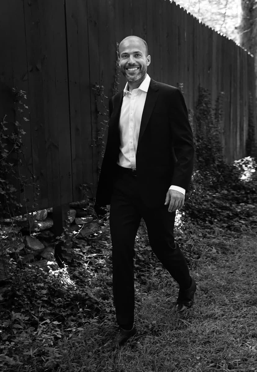 A black and white photo of a man in a suit