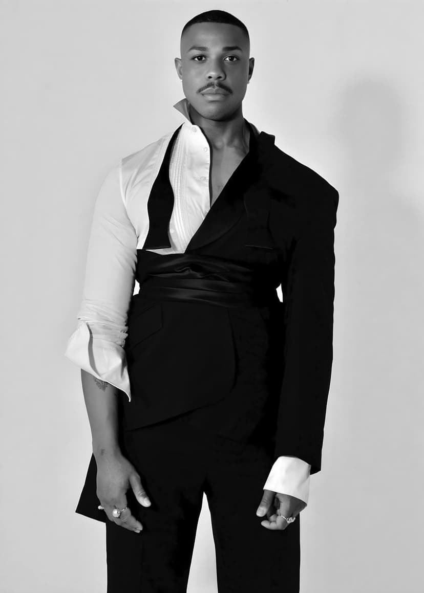 A man in a suit and tie poses for a picture