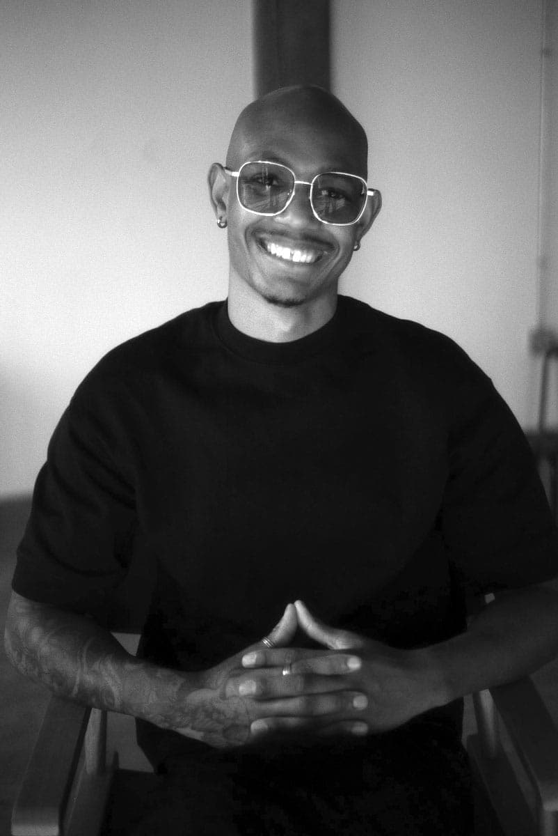 A man sitting in a chair with a smile on his face