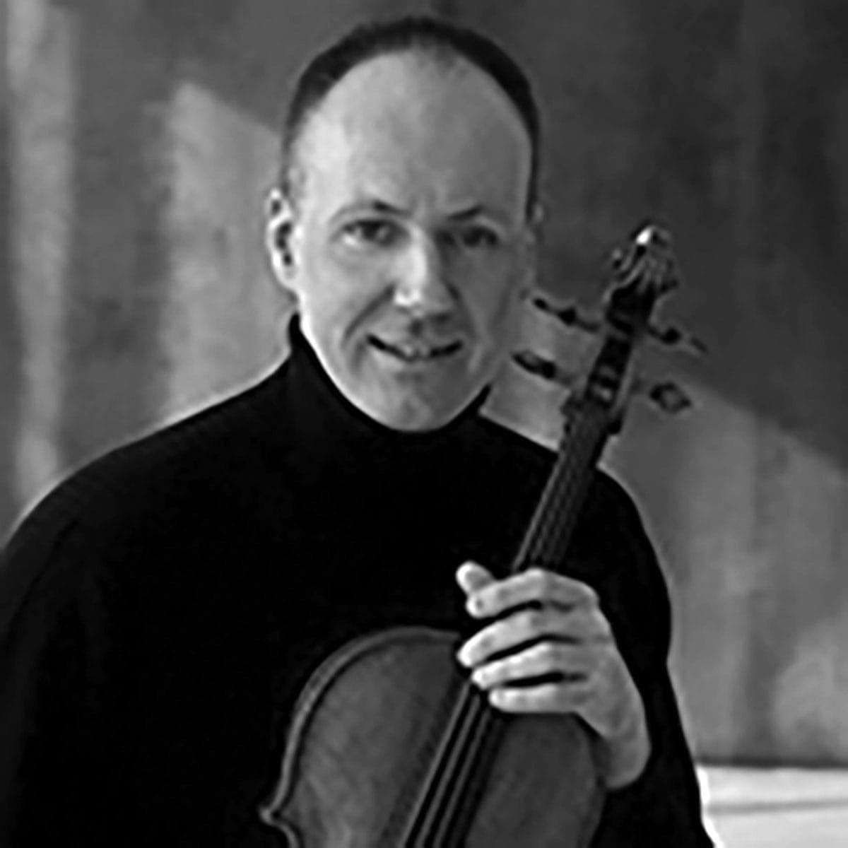 A man holding a violin in his right hand