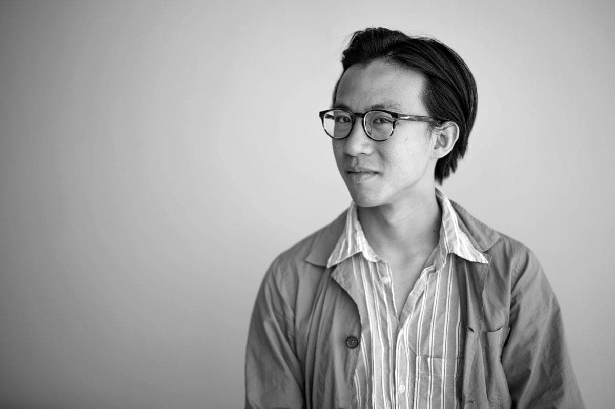A black and white photo of a person wearing glasses