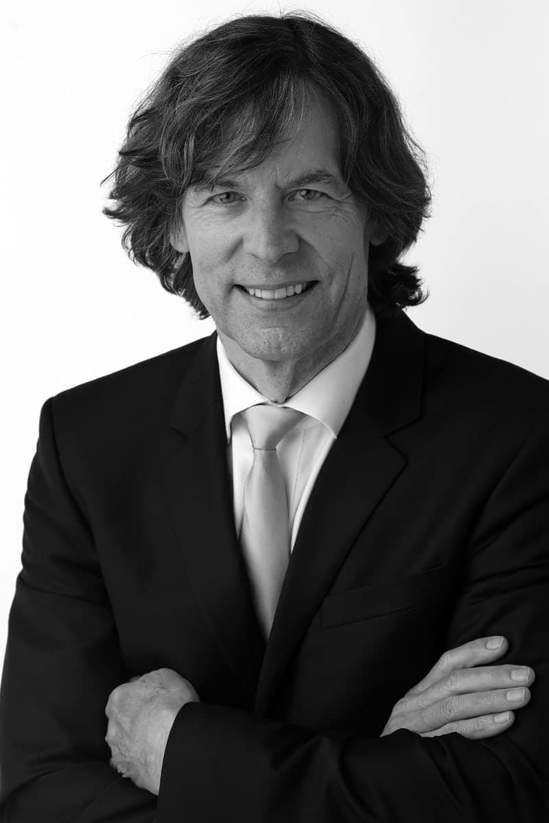 A black and white photo of a man in a suit and tie