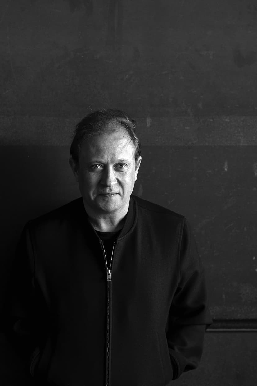 A black and white photo of a man in a jacket