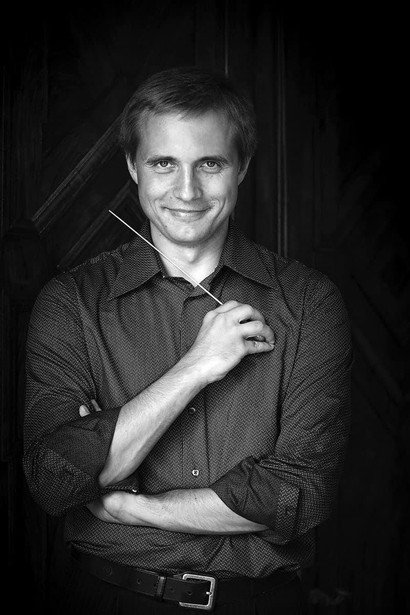 A black and white photo of a man smiling