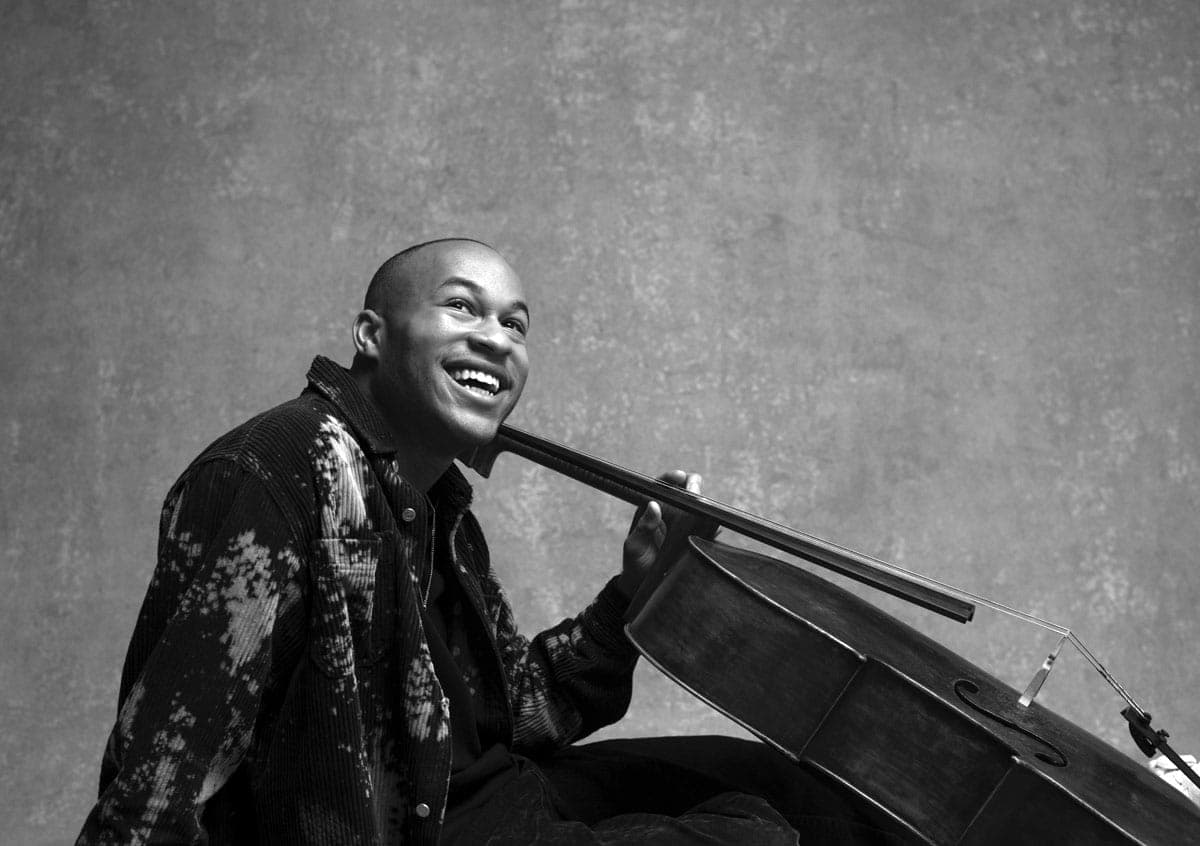 A man sitting on the ground holding a piano
