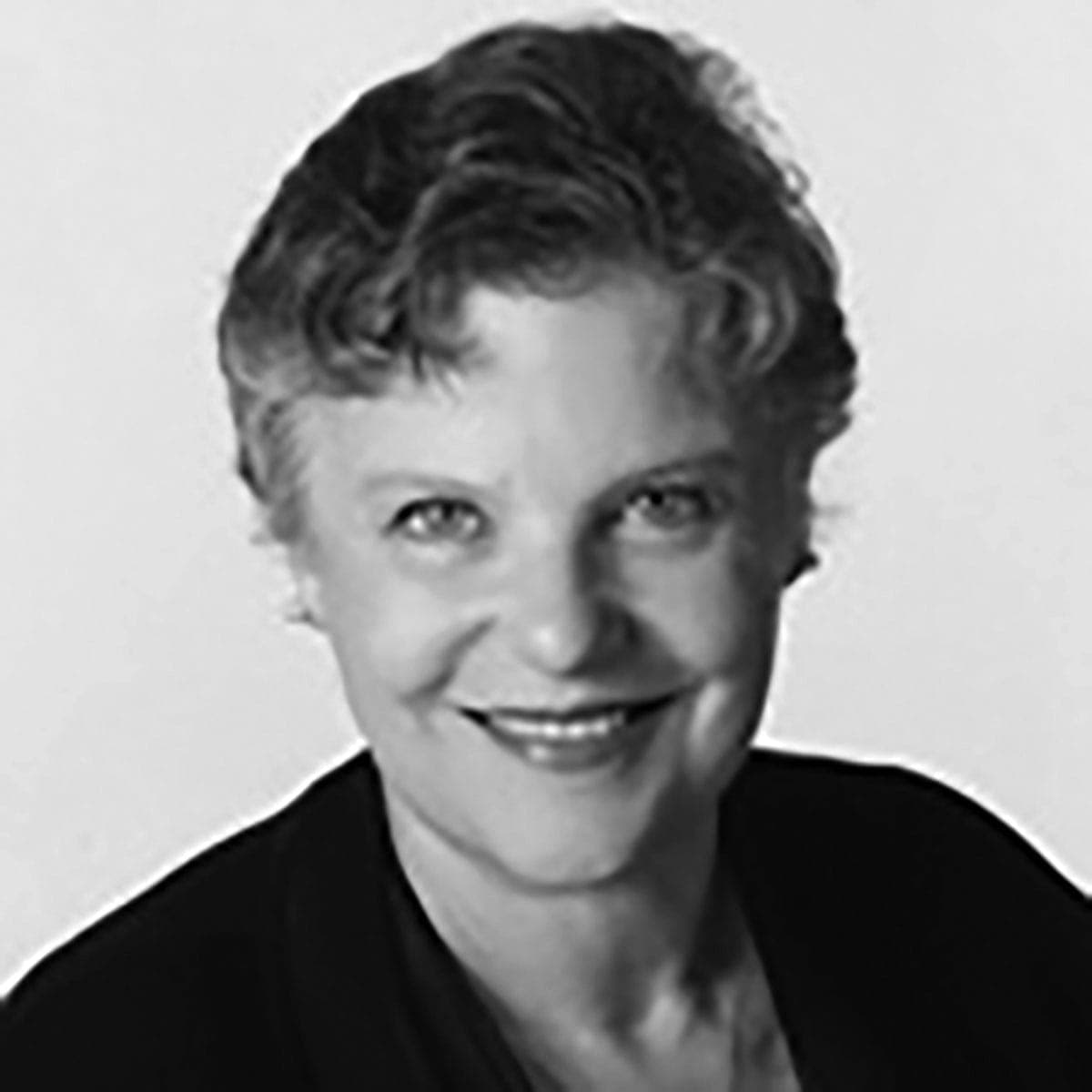 A black and white photo of a woman smiling