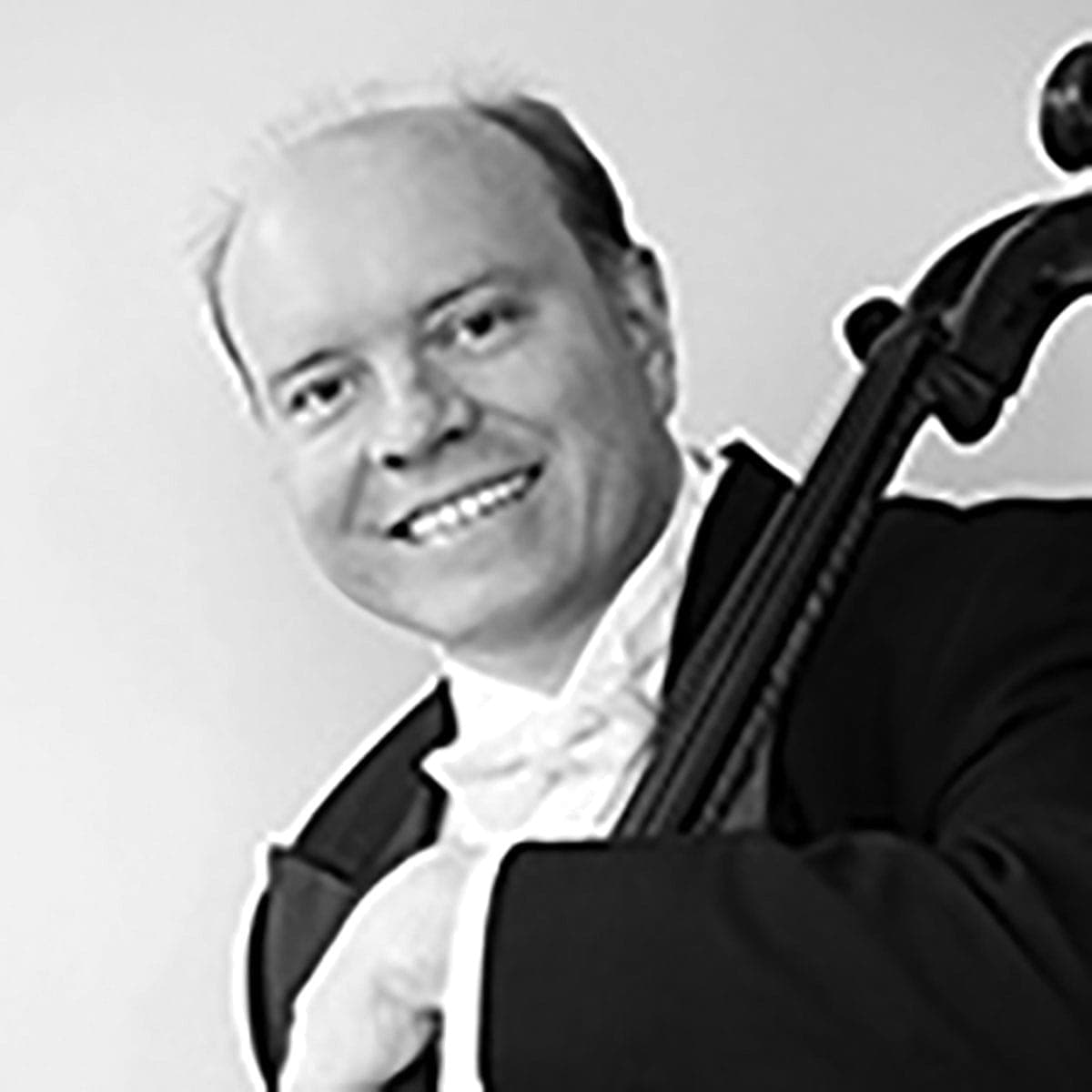 A man in a tuxedo holding a violin