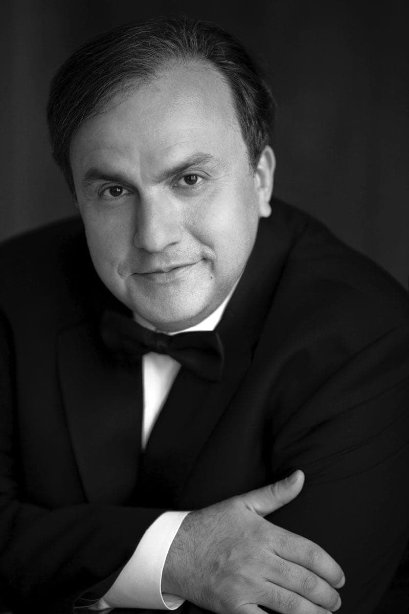 A black and white photo of a man in a tuxedo