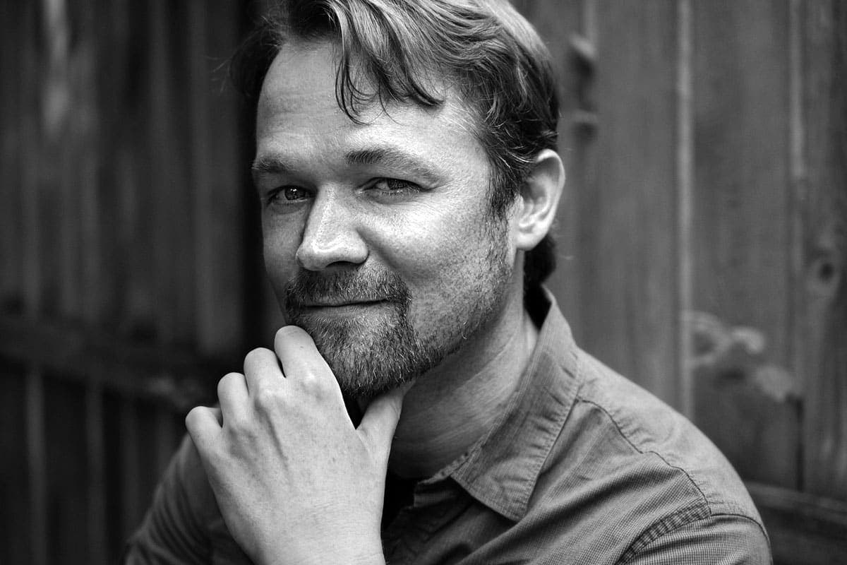 A black and white photo of a man with a beard
